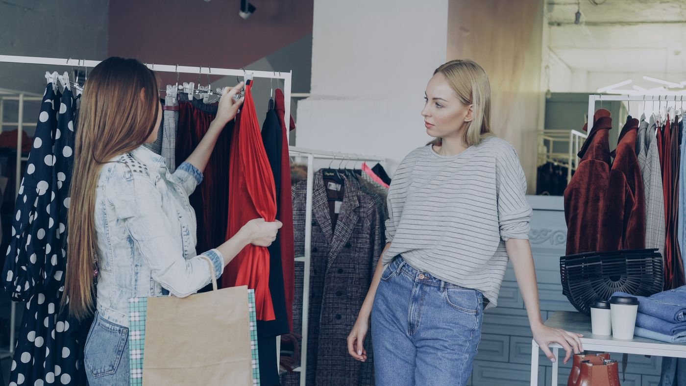 Two women browsing the Lakeside Essentials showroom rail